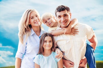 Beautiful smiling lovely family on outdoor background