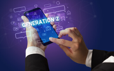 Female hand typing on smartphone with GENERATION Z inscription, social media concept