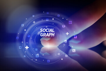 Finger touching tablet with social media icons and SOCIAL GRAPH