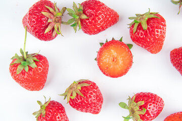 several strawberries are removed from the glare on a white background