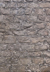 old town flooring with gray stone tiles - vertical wallpaper of an ancient roman road