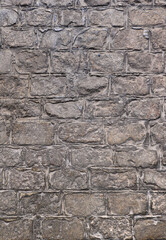 old town flooring with gray stone tiles - vertical wallpaper of an ancient roman road