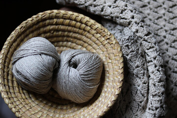 close up of natural linen balls of yarn in basket