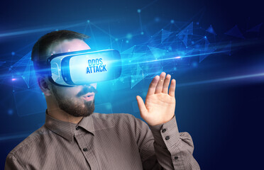 Businessman looking through Virtual Reality glasses with DDOS ATTACK inscription, cyber security concept