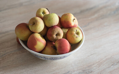 organic farm apples in a bowl on a marble table
