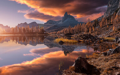 Fototapeta na wymiar Fantastic colorful scenery in mountains during sunset. Fabulous landscape over calm mountain lake Federa in the summer morning, picture of Wild area. Stunning Natural Background. Creative image