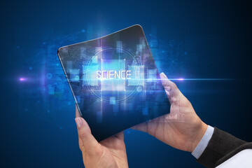 Businessman holding a foldable smartphone with SCIENCE inscription, new technology concept