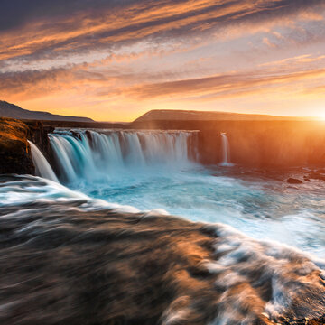 Fantastic nature landscape of Iceland during sunset. Wonderful View on Godafoss Waterfall with colorful sky. Travel on car is a Lifestyle, conception. Idea of Adventure lifestyle. Popular travel place