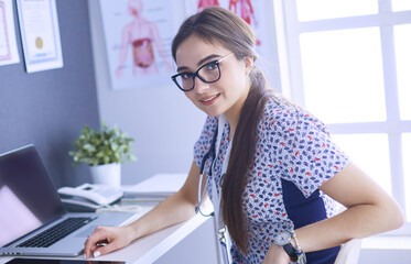 Two doctors speaking in a bright office