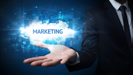 Hand of Businessman holding MARKETING inscription, successful business concept