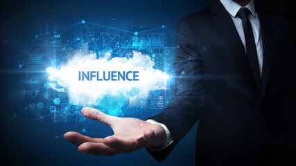 Hand of Businessman holding INFLUENCE inscription, successful business concept