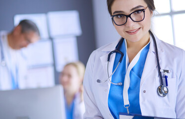 Female doctor using tablet computer in hospital lobby