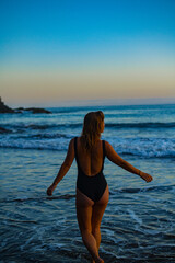 Fototapeta na wymiar woman in a bikini posing on the beach