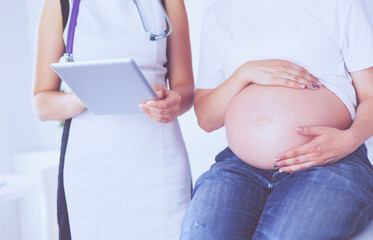 Young female doctor examining pregnant woman at the clinic.