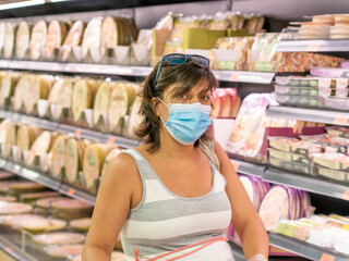 YOUNG WOMAN WITH MASK IN THE SUPERMARKET