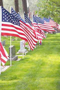 Original patriotic photograph of American flags on headstones in a cemetery on Memorial Day