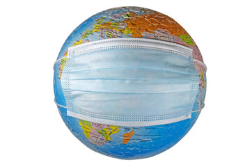 A surgical face mask putting on a world globe protecting the world from pollution and infectious diseases (closeup, isolated on white background)