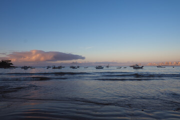 sunrise  on the beach with fishing boats 