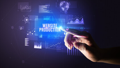 Hand touching WEBSITE PRODUCTION inscription, new business technology concept