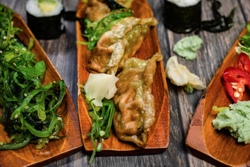 Japanese food of gyoza, seaweed spices and sushi 