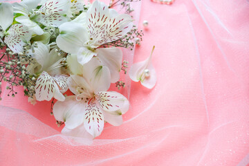 bouquet of white flowers on a pink background and space for text. wedding card. congratulation. invitation