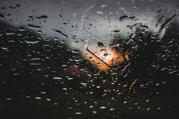 Rain drop on the window glass. Sunset in background