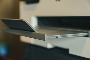 Home office equipment of a narrow focus on a printer outfeed tray