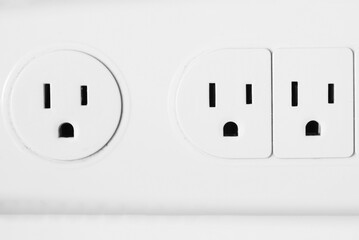 Original photograph of the outlets in a power strip appearing to be making shocked faces like Pareidolia