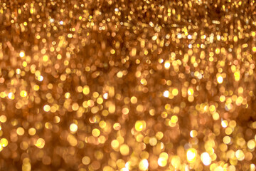 Abstract festive background with golden bokeh of different sizes