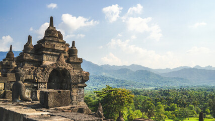 Fototapeta premium Borobudur Temple in Indonesia, South East Asia, UNESCO World Heritage Site, blue sky and sunny warm weather in summer, best season to visit Indonesia, sightseeing tour