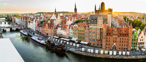 Fototapeta na wymiar Gdansk, North Poland : Wide angle panoramic aerial shot of Motlawa river embankment in Old Town during sunset / sunrise in summer