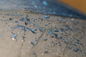 Drops of water on a waterproof black fabric