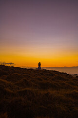 woman on a mountain at sunset