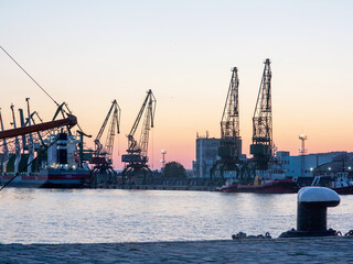 Varna, Bulgaria - July 23, 2016: View on seaport with cranes, cargo and passenger ships at sunset,...