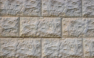 Gray rough tiles on the wall. background texture