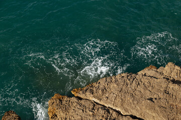 Clear amazing azure colour sea water with rocks in Spain. View of sea waves and fantastic Rocky coast. Stone rock close up in the sea water. Rock and sea.