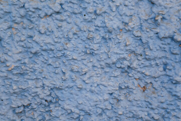 non uniform wall covered with blue paint