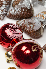 Festive background with Christmas ornaments. Randomly placed Xmas tree toys and pine cones