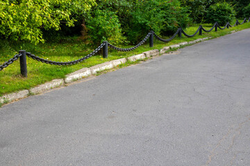 Forged iron chain.Fragment of a decorative street fence