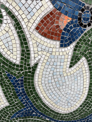Fototapeta na wymiar Detail of beautiful old collapsing abstract ceramic mosaic adorned building. Venetian mosaic as decorative background. Selective focus. Abstract Pattern. Abstract mosaic colored ceramic stones