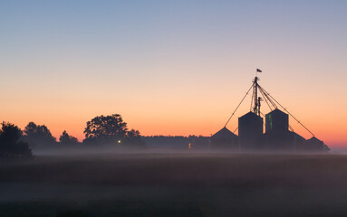 A midwest farm silhouetted at dawn - obrazy, fototapety, plakaty