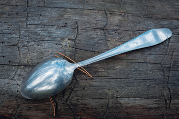 Old iron spoon on wood