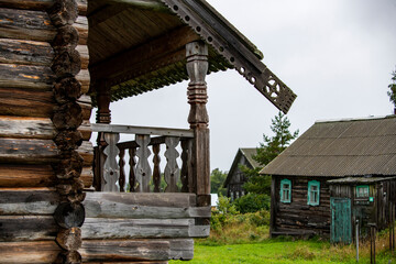 old wooden church on the island between trees in the rain