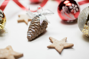 Festive background with Christmas ornaments. Randomly placed Xmas tree toys and pine cones