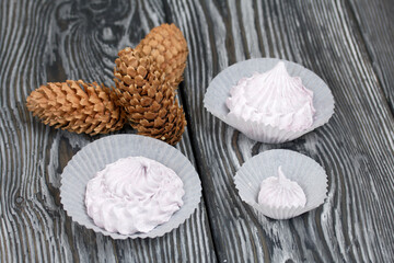 Zephyr  and spruce cones. On painted pine planks.