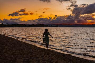 woman on a beach at sunset