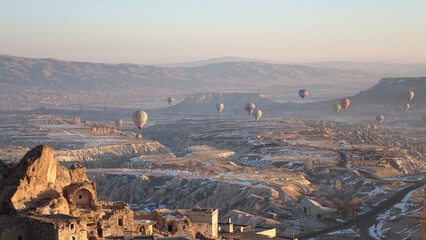 Hot Air Balloons rising in the sky during sunrise in Cappadocia in Göreme, Turkey.