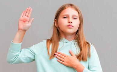 Optimistic, honest and cute girl give oath, swear tell truth, put hand on heart and raise one arm...