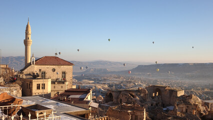Fototapeta na wymiar Hot Air Balloons rising in the sky during sunrise in Cappadocia in Göreme, Turkey.