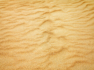 closeup of sand pattern of a beach in the summer